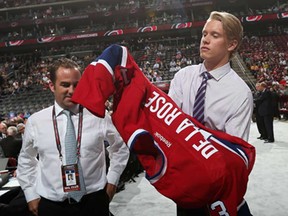 Jacob De la Rose, right, puts on a Montreal Jersey after being drafted by the Canadiens in June.
(Bruce Bennett/Getty Images)