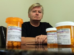 Linda Ripley is seen with some of the pain medication she takes at her home in Windsor on Friday, July 26, 2013. Ripley's family doctor is closing his practice and now she can't find a physician willing to take her on because she uses the prescription narcotic painkillers for her back problems.            (TYLER BROWNBRIDGE/The Windsor Star)