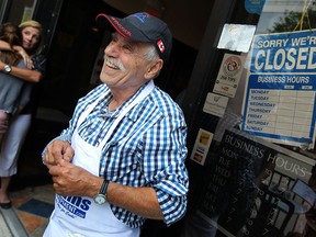 Elias Sleiman talks with customers after flipping the closed sign for the last time on the last day of the Elias Deli in Windsor on Friday, July 26, 2013. After 45 years owner Elias Sleiman is retiring and closing his landmark deli.              (TYLER BROWNBRIDGE/The Windsor Star)