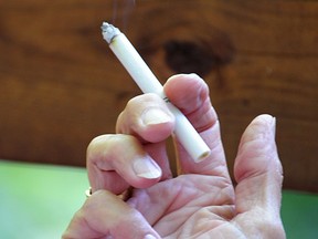 A woman holds a cigarette. (Associated Press files)