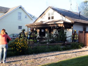 Windsor firefighters check the aftermath of a house fire at 1583 Hickory Rd. in Windsor, Ont. on July 12, 2013. (Dylan Kristy / The Windsor Star)