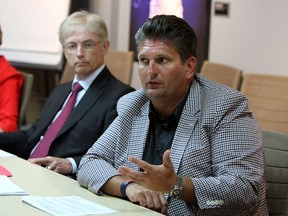 Windsor Regional Hospital president and CEO David Musyj, right,and Ken Deane, CEO of Hotel-Dieu Grace Hospital talk about hospital restructuring during an editorial board meeting at the Windsor Star on Wednesday, July 24, 2013.              (TYLER BROWNBRIDGE/The Windsor Star)