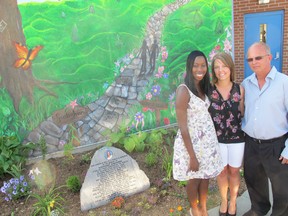 Lorraine Oloya (left), Melissa Kinghorn (middle) and Wayne Kinghorn unveiled a peace garden and mural dedicated to Stephanie Kinghorn, who killed herself because of bullying 10 years ago.