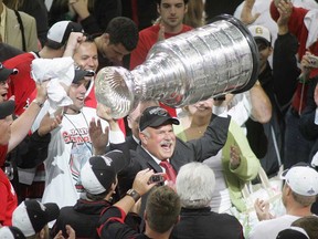 Carolina Hurricanes owner Peter Karmanos Jr. hoists the Stanley Cup after Game 7 between the Hurricanes and the Edmonton Oilers of the 2006 NHL Stanley Cup Final. (Photo by Bruce Bennett/Getty Images)