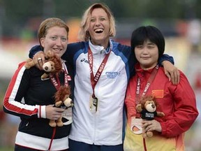 Windsor’s Virginia McLachlan, left, poses with her silver medal alongside Italian gold medallist Oxana Corso, centre, and  Chinese bronze medallist Ping Liu after the women’s T35 100m final 
at the IPC Athletics World Championships Monday at the Rhone Stadium in France. (PHILIPPE MERLEPHILIPPE MERLE/AFP/Getty Images)