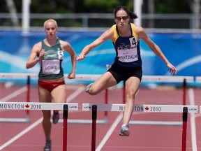 Windsor's Noelle Montcalm races to victory in the women's 400-metre hurdles at the Canadian Track and Field championships in Moncton, N.B., June 23, 2013. Montcalm will race for the national team in the FISU Games in Kazan, Russia. (THE CANADIAN PRESS/Andrew Vaughan)