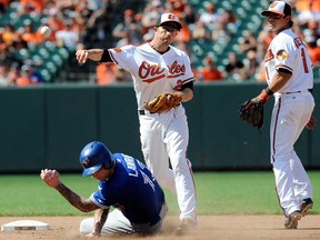 Baltimore's J.J. Hardy, centre, forces out Toronto's Brett Lawrie at second base in the ninth inning at Camden Yards on July 14, 2013 in Baltimore. (Greg Fiume/Getty Images)
