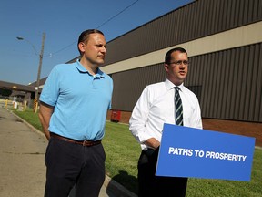 Robert de Verteuil, Ontario PC Party candidate for Windsor-Tecumseh (L), stands next to provincial Tory caucus member Monte McNaughton at Windsor's former GM transmission plant on July 19, 2013. (Tyler Brownbridge / The Windsor Star)