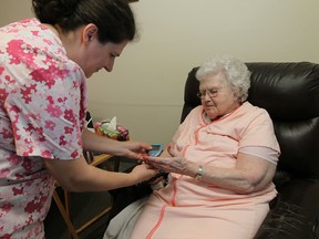 Nurse Tanja Popovska checks Madeleine Little's blood sugar at La Chaumiere Retirement Residence in Lakeshore in this June 2013 file photo. (TYLER BROWNBRIDGE/The Windsor Star)
