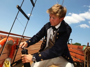 Ryan Tilley, 22, fills a barrel with gun powder on the Liana's Ransom at King's Navy Yard Park in Amherstburg, Ont., Friday, July 12, 2013.  The ship was damaged in a severe storm earlier in the week.  (DAX MELMER/The Windsor Star)