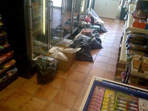 Bags and boxes full of hundreds of cartons of illegal cigarettes at a Westcott Road convenience store in the east end of Windsor, Ont. on July 17, 2013. (Handout / The Windsor Star)