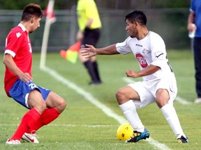 Windsor Stars midfielder Cristian Mayorga, right, stops the ball from going out of bounds in front of Serbian White Eagles midfielder Daniel Chamale at Windsor Stadium Saturday, July 27, 2013. The White Eagles shut out the Stars 3-0. (JOEL BOYCE/Windsor Star)