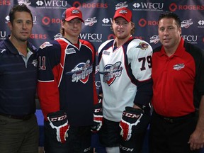 Spitfires coach Bob Boughner, from left, Nikita Yazkov, Ty Bilcke, and GM Warren Rychel show off the team's new jerseys at the WFCU Centre, Friday, July 12, 2013.  (DAX MELMER/The Windsor Star)