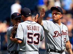 Detroit's Victor Martinez, left,  and Miguel Cabrera, right, congratulate closer Joaquin Benoit the Tigers defeated the Kansas City Royals 4-1 to win at Kauffman Stadium on July 21, 2013 in Kansas City, Missouri.  (Photo by Jamie Squire/Getty Images)