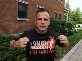 David Low of Amherstburg shows off his Tough Mudder Finisher T-shirt, earned on a mud-covered 12-mile obstacle course in Michigan last weekend. Photographed July 4, 2013. (Jason Kryk / The Windsor Star)