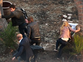 Actors Mark Wahlberg, top, Jack Reynor, centre, and Stanley Tucci, are pictured filming an action scene on the set of Transformers 4 in downtown Detroit, MI, Wednesday, July 31, 2013.  (DAX MELMER/The Windsor Star)