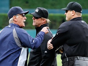 Tigers manager Jim Leyland, left, argues with home plate umpire Chad Fisher, right, in front of first base umpire Jeff Kellogg after Miguel Cabrera was ejected in the third inning against the Philadelphia Phillies at Comerica Park on July 28, 2013 in Detroit. Leyland was also ejected. (Gregory Shamus/Getty Images)