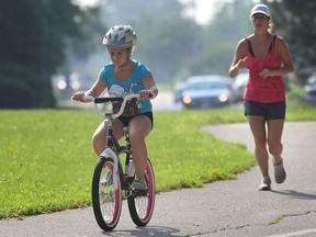 Hailey Campbell, 9, was keeping her mom Des Campbell company as she ran Wednesday, July 10, 2013, along the Ganatchio trail in Windsor, Ont. (DAN JANISSE/The Windsor Star)