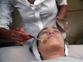 In this Wednesday, July 17, 2013 photo, salon owner Shizuka Bernstein gives what she calls a Geisha Facial to Mari Miyoshi at Shizuka New York skin care in New York. The facial, which Bernstein has been offering for five years, is a traditional Japanese treatment using imported Asian nightingale excrement mixed with rice bran, and goes for $180 a pop. (AP Photo/Mary Altaffer)