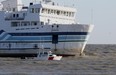 A volunteer auxillary vessel, the Colchester Guardian, passes the Jiimaan after the Pelee Island ferry ran aground in Lake Erie near Kingsville in October 2012.  The ferry was delayed Sunday afternoon, August 4, 2013, due to a mechanical problem. (Windsor Star files)