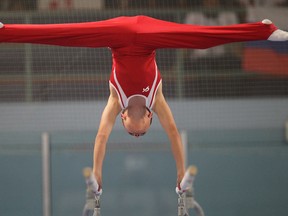 Windsor-Essex's Daniel Hodare competes on the parallel bars, 
Saturday, August 17, 2013, at the International Children's Games in Windsor.   (DAN JANISSE/The Windsor Star)