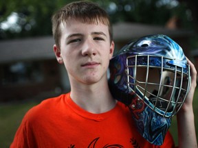 Tecumseh, ONT.: August 31, 2013 -- Jax D'Hondt, 14, holds a hockey mask he had painted and designed in honour of his best friend, Daniel Ethier, on Saturday, August 31, 2013. Ethier died from cancer in June. (DAX MELMER/ The Windsor Star)