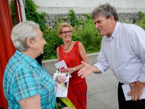 Liberal candidate for Ottawa South, John Fraser and Ontario Premier Kathleen Wynne greets a commuter during the campaign for the  byelection in August, at Billings Bridge bus station on Friday, July 19, 2013. (James Park/Postmedia News)