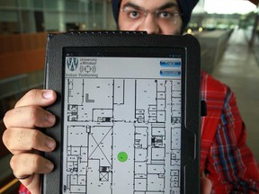 Paramvir Nagpal, 22, holds a tablet showing a UWin IPS app at the Centre for Innovation Engineering at the University of Windsor, Tuesday, Aug. 13, 2013.  (DAX MELMER/The Windsor Star)