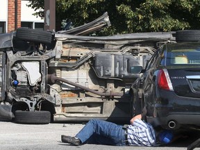 A cleanup crew deals with vehicles involved in a collision Thursday, Aug. 1, 2013, at Lesperance Road and Arbour Street in Tecumseh, Ont. The accident occurred shortly after 9 a.m. between a Ford Lincoln and a Pontiac Montana minivan. No one was injured. (DAN JANISSE/The Windsor Star)