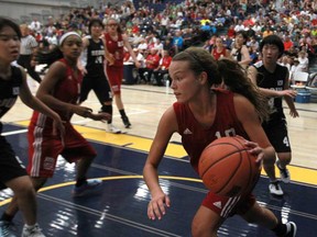 Windsor-Essex's Brielle Loeback, right, drives to the hoop against Seoul, South Korea during the girls basketball gold medal game in the International Children's Games at the St. Denis Centre in Windsor, Ont., Sunday, August 18, 2013.  (DAX MELMER/The Windsor Star)