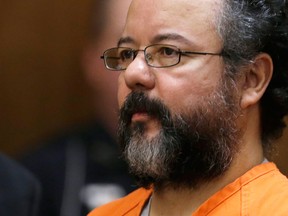 Ariel Castro listens in the courtroom during the sentencing phase Thursday, Aug. 1, 2013, in Cleveland. Three months after an Ohio woman kicked out part of a door to end nearly a decade of captivity, Castro, a onetime school bus driver faces sentencing for kidnapping three women and subjecting them to years of sexual and physical abuse. (AP Photo/Tony Dejak)