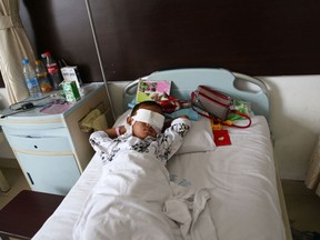 Guo Bin recuperates from an attack in the rural area of Linfen city that left him blind, in a hospital in Taiyuan in northwest China's Shanxi province on Wednesday, Aug. 28, 2013. A woman tricked the 6-year-old boy into going into a field, and then gouged out his eyes, police said Wednesday. (AP/Getty Images)