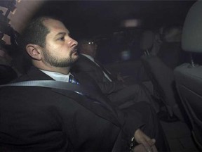 City of Toronto Police Constable James Forcillo is pictured through an unmarked police van as he arrives at the Old City Hall courthouse facing second degree murder charges from the shooting of Sammy Yatim in Toronto, on Tuesday, August 20, 2013. (THE CANADIAN PRESS/Nathan Denette)
