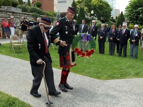 Dieppe veteran Howard Large and Honorary Colonel Hardy Wheeler (right) lay a wreath during the annual service to mark the Dieppe Raid in Dieppe Park in Windsor on Monday, August 19, 2013. (TYLER BROWNBRIDGE/The Windsor Star)