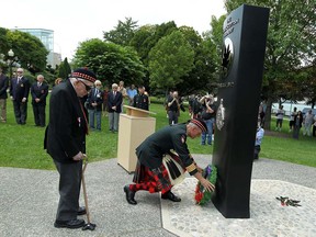 Dieppe veteran Howard Large and Honorary Colonel Hardy Wheeler (right) lay a wreath during the annual service to mark the Dieppe Raid in Dieppe Park in Windsor on Monday, August 19, 2013. (TYLER BROWNBRIDGE/The Windsor Star)