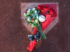 A floral tribute rests on the home plate at the Essendon Baseball Club on August 20, 2013 in Melbourne, Australia. Australian Chris Lane was shot dead in Duncan, Oklahoma on Friday local time. Three teenage males have now been accused of the murder.  (Scott Barbour/Getty Images)