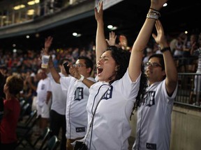 Tigers fans celebrate after Miguel Cabrera hit a walk-off home-run to beat the Kansas City Royals at Comerica Park, Saturday, August 17, 2013.  (DAX MELMER/The Windsor Star)