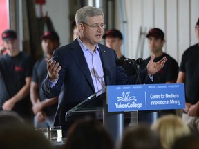Prime Minister Stephen Harper delivers a statement at Quantum Machine Works Ltd., in Whitehorse on Monday, August 19, 2013. (THE CANADIAN PRESS/Sean Kilpatrick)