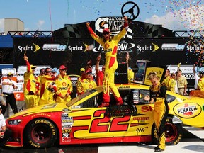 Joey Logano, driver of the #22 Shell-Pennzoil Ford, celebrates in Victory Lane after winning the NASCAR Sprint Cup Series 44th Annual Pure Michigan 400 at Michigan International Speedway on August 18, 2013 in Brooklyn, Mich.  (Jerry Markland/Getty Images)