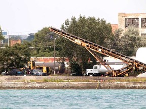 Crews continue to remove the petroleum coke piles on the banks of the Detroit River in Detroit.  (JASON KRYK/The Windsor Star)