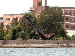 Crews continue to remove the Petroleum Coke Piles banks of the Detroit River in Detroit Michigan.  (JASON KRYK/The Windsor Star)