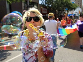 Krystina Bigelow blows bubbles while participating in the 2013 Pride Parade in downtown Windsor, Ontario on August 11, 2013. (JASON KRYK/The Windsor Star)