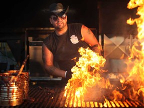 Josh Vantam works the barbecue for Ribs Royal at Windsor Ribfest at the Riverfront Festival Plaza, Saturday, August 24, 2013.  (DAX MELMER/The Windsor Star)