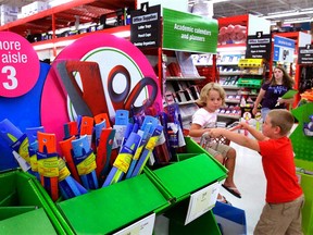 In this Aug. 24, 2009 file photo, young shoppers cruise the aisles looking for back to school supplies at the Staples Office Supply store in Springfield, Ill. dians will be digging a little deeper into their pockets during this year's back-to-school shopping season, a new survey suggests. THE CANADIAN PRESS/AP, Seth Perlman