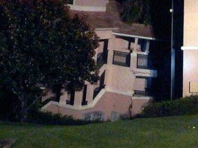 A section of a building at the Summer Bay Resort in Clermont, Fla., shows damage from collapsing into a sinkhole early Monday Aug. 12, 2013. The villa at the Summer Bay Resort already had been evacuated and no injuries were reported. (AP Photo/Alma Rodriquez)