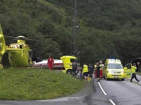 Emergency personel attend the scene of a truck fire in a tunnel near Bergen Norway Monday Aug. 5, 2013. Police say 55 people have been taken to hospitals following a truck fire in Norway’s second-longest tunnel. Police spokesman Jorn Lasse Refnes says the truck caught fire 3.5 kilometers (2.17 miles) into the tunnel, in a district west of Bergen. He said it is unclear how seriously injured the people taken for medical care were, and that many had suffered due to smoke inhalation. (AP Photo/Arne Veum / NTB scanpix)