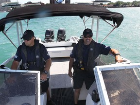 Windsor Police Service Const. Dale Harvie (L) and Const. Henry Penner of the department's marine unit patrol the Detroit River in east side of the city Friday, Aug. 2, 2013. They along with other police agencies will be enforcing safe boating practices this upcoming long weekend. (DAN JANISSE/The Windsor Star) (