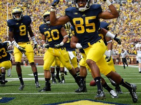 Michigan's Joe Reynolds, right, celebrates returning a first quarter blocked punt for a touchdown against the Central Michigan Chippewas at Michigan Stadium Ann Arbor Saturday. (Photo by Gregory Shamus/Getty Images)