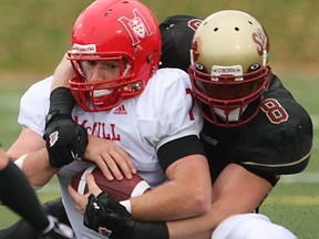 Concordia Stingers linebacker Cory Greenwood, right, tackles McGill Redmen quarterback Jonathan Collin in 2009. Greenwood was cut by the Detroit Lions Monday. (JOHN MAHONEY/The Gazette)