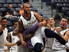 Lancers guard Enrico Di Loreto is congratulated by teammates and coaches after sinking the final shot with less than 1.8 seconds to beat The Citadel at the St. Denis Centre. (NICK BRANCACCIO/The Windsor Star)